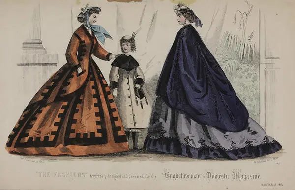 Two women and child in Victorian fashion with brightly coloured capes